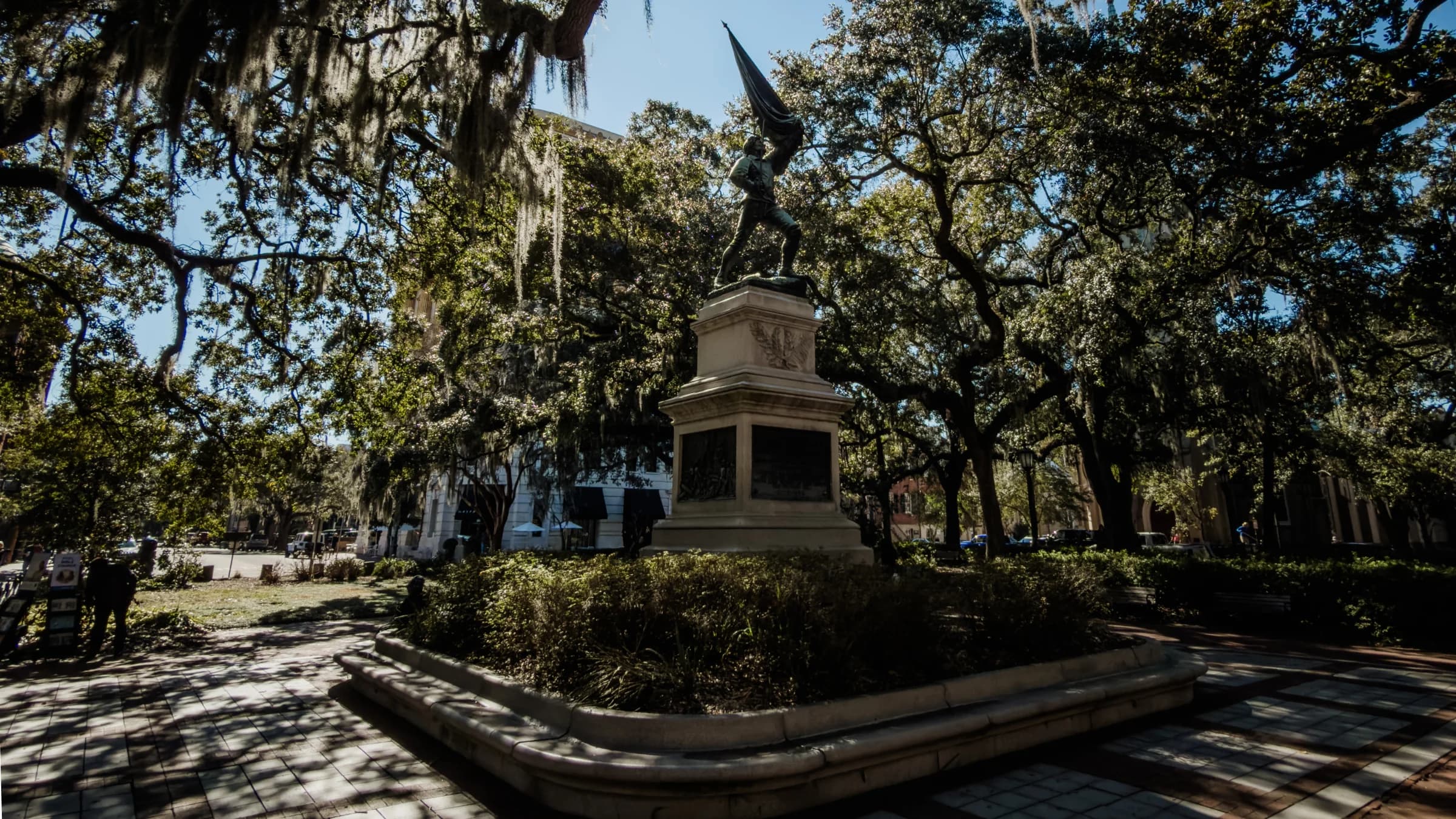 The monument under Madison Square's live oaks